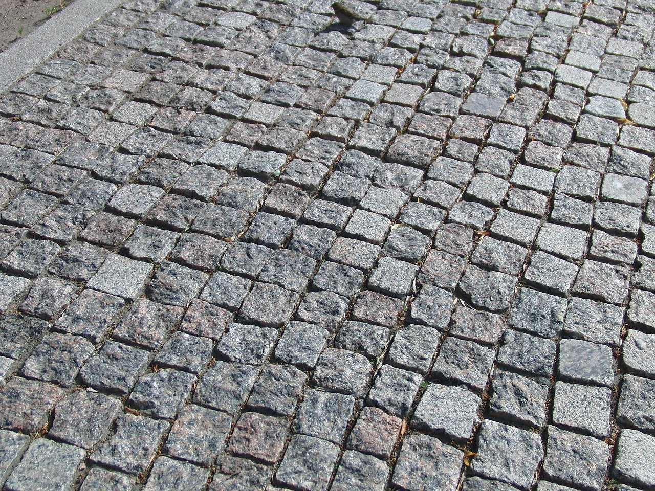 Paving stone made of granite, which contains quartz mineral.